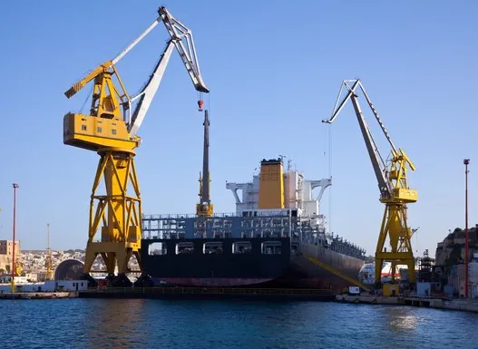 Harbour cranes above a cargo vessel – cargo vessel equipment