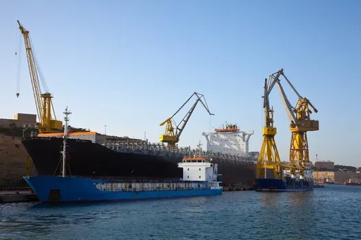 Cargo ship at port with yellow cranes – fast worldwide delivery